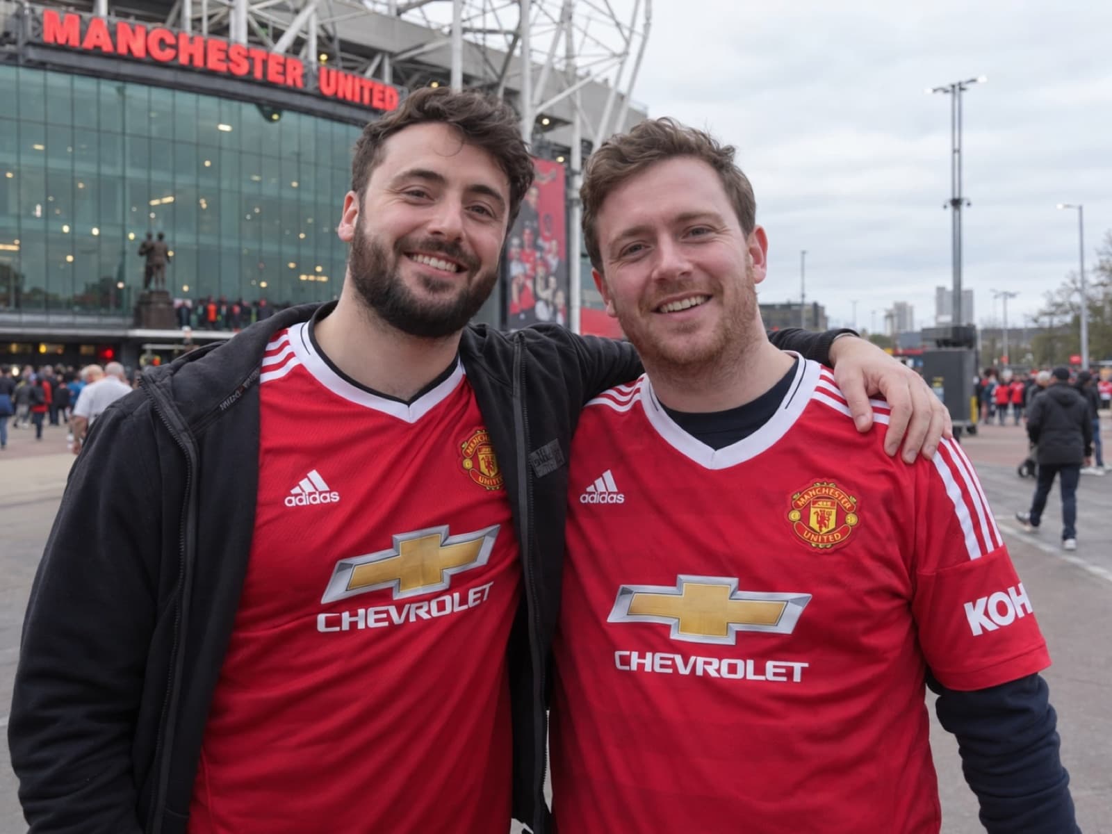 Two Manchester United fans outside Old Trafford on matchday